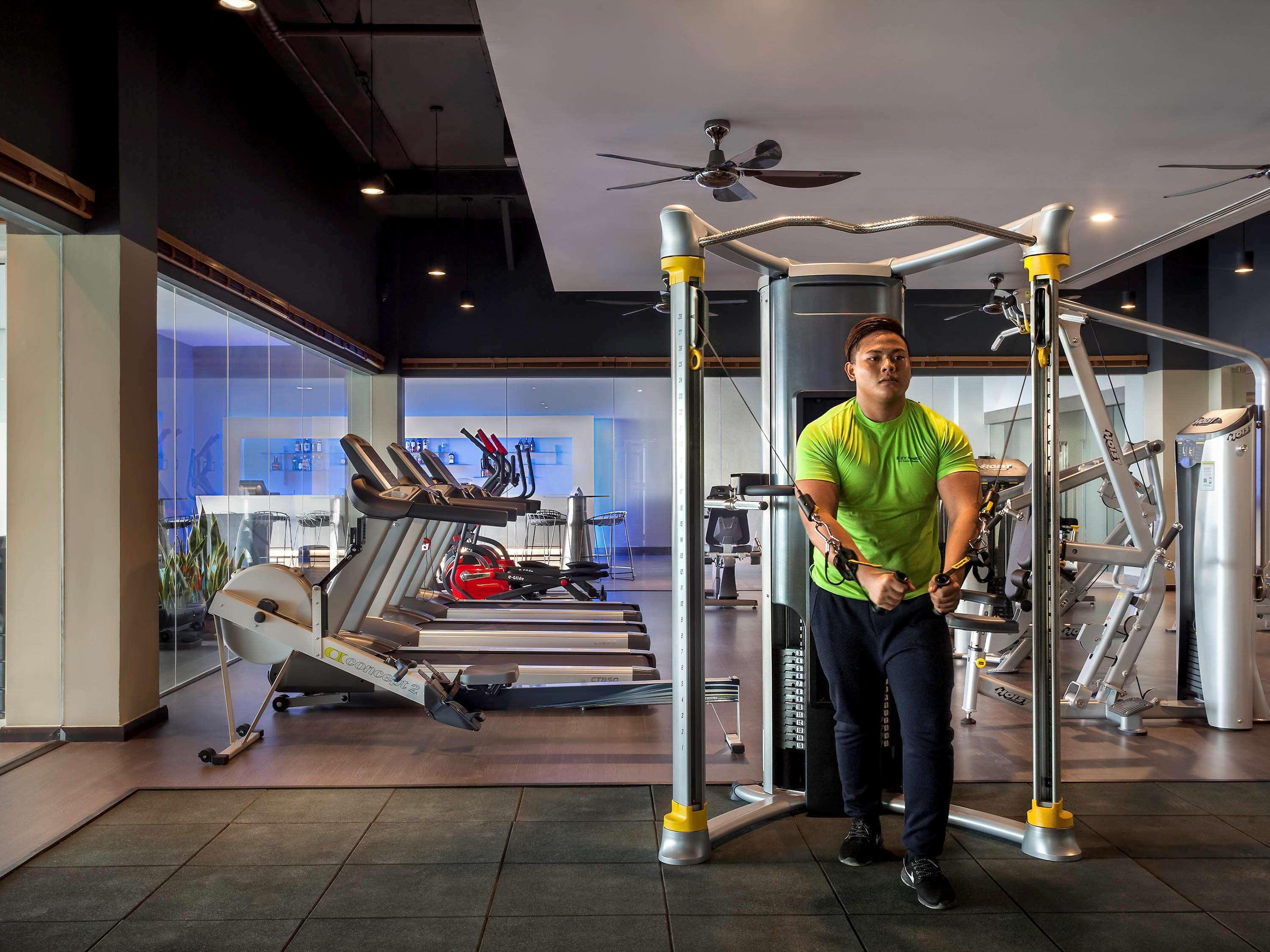 Hotel Pullman Miri Waterfront Esterno foto A man doing dips on a parallel bar